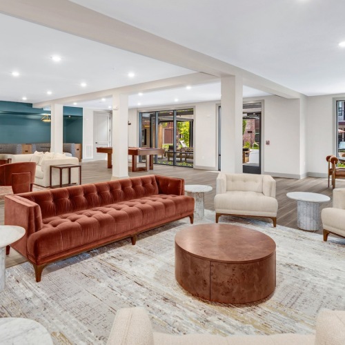 a clubroom with couches, tables and chairs