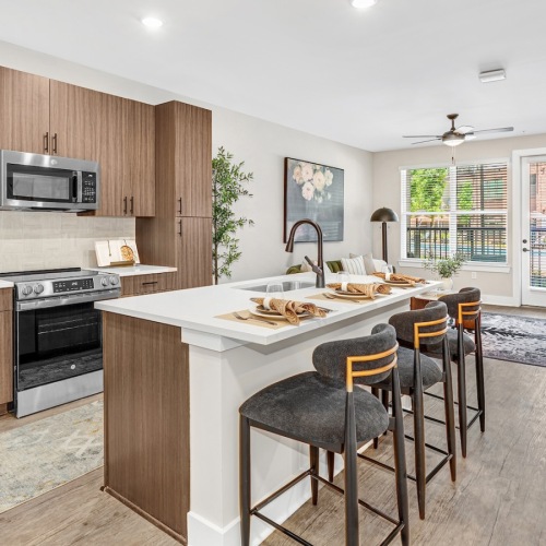 a kitchen with an island and chairs