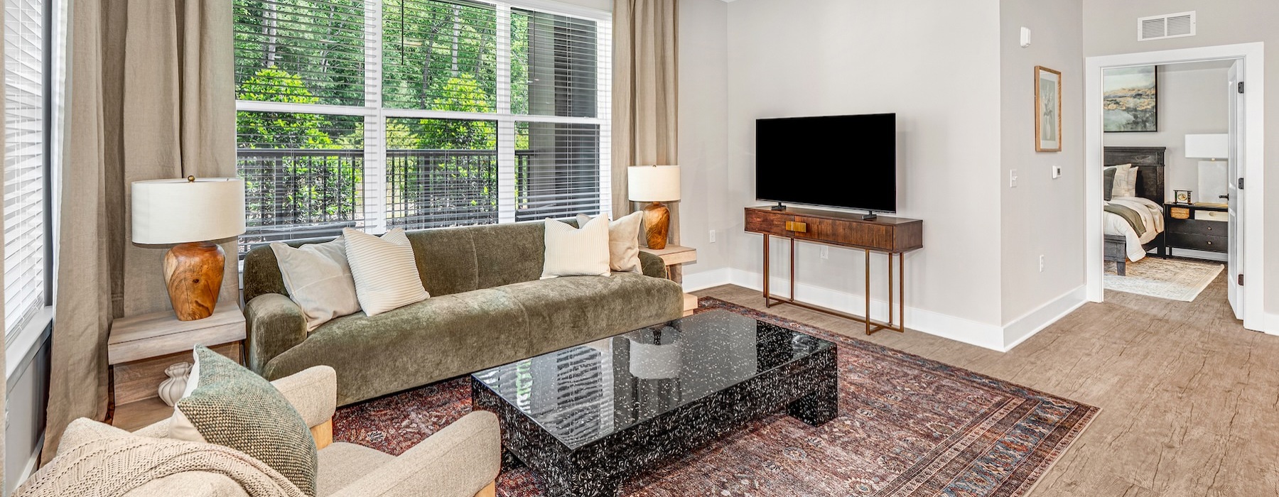 a living room with a couch, chair, tv and coffee table