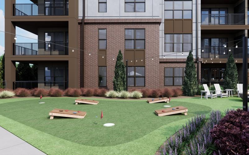 a building with a lawn and chairs