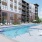 The pool area at Weller at the Preserve senior apartments in Asheville, NC, featuring lounge chairs and umbrellas.